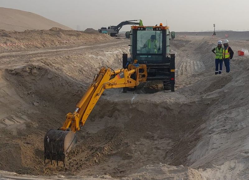 Backhoe loader digging a trench
