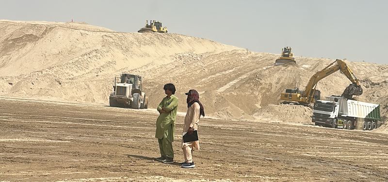 Bulldozers, a wheel loader and an excavator working on a large earthworks site