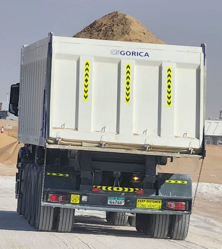 Tipper trailer loaded with sand, seen from behind