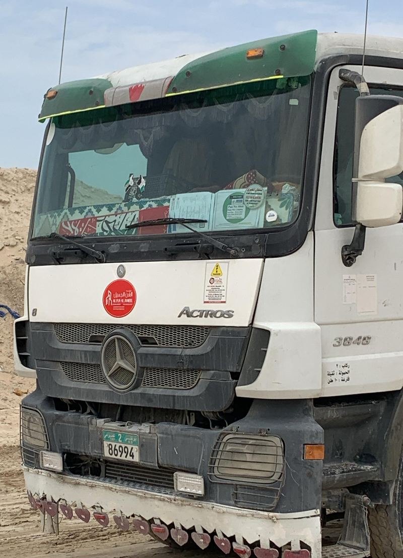Front of a company truck showing the Al Fun Al Jameel sticker